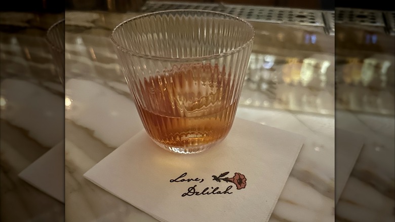 liquor drink on the rocks on Delilah lounge napkin