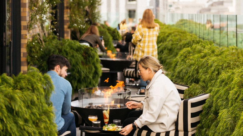 People eating and drinking at Charmaine's rooftop bar