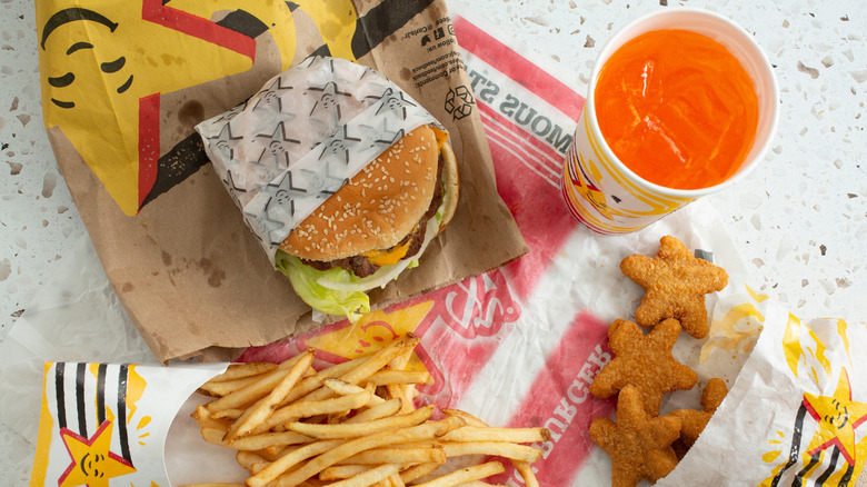 Top view of a cheeseburger, fries, nuggets, and soft drink at Carl's Jr.
