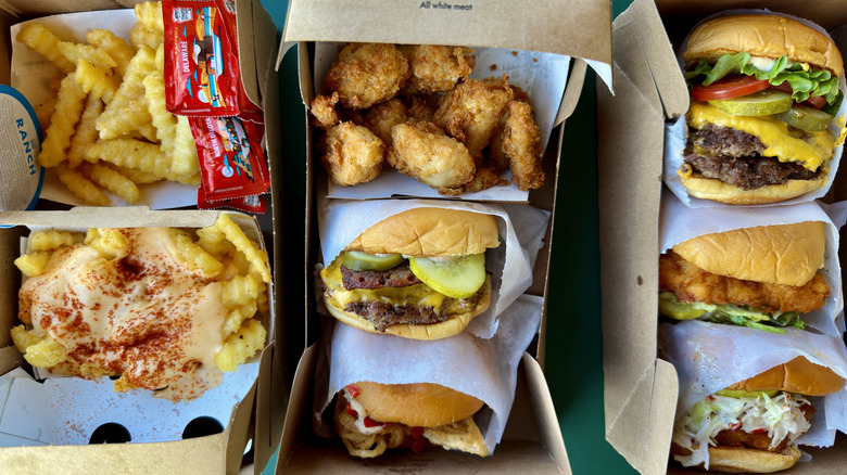 Assorted Shake Shack items like burgers and fries in boxes