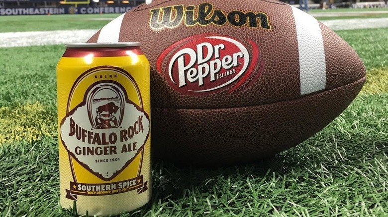 Can of Buffalo Rock Ginger Ale with a football on a field
