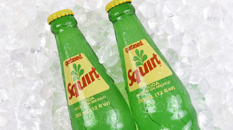 Two bottles of Squirt soda on ice