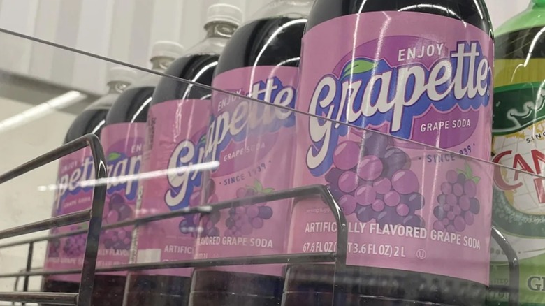 Grapette bottles on a store shelf with a bottle of Canada Dry