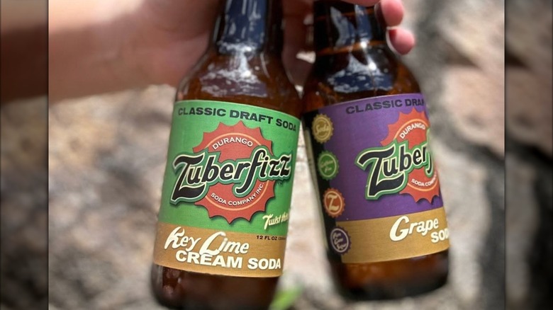 Hand holding two bottles of Zuberfizz
