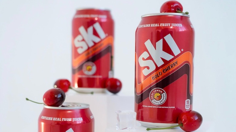 Cans of Ski soda with cherries on a white background