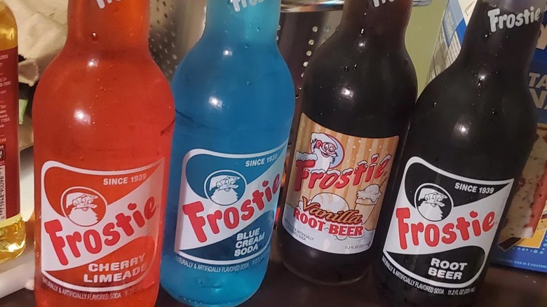 Four bottles of Frostie sodas on a tabletop