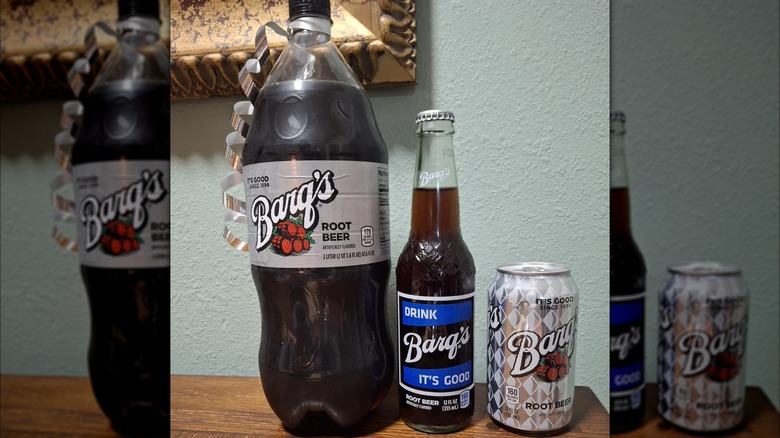 Two-liter, glass bottle, and can of Barq's root beer