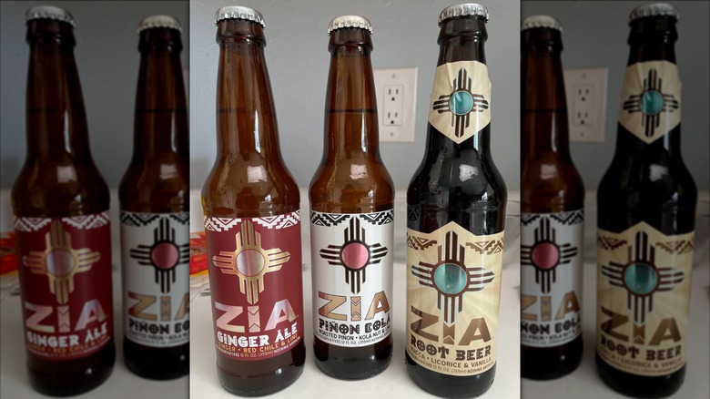 Three bottles of Zia's ginger ale, piñon cola, and root beer