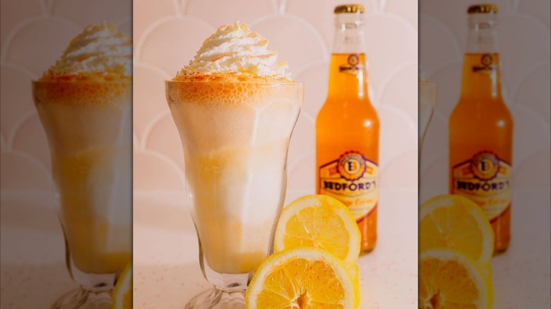 Bedford's orange soda bottle with sliced oranges and a float