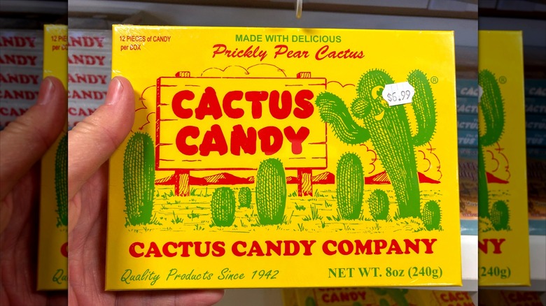 Hand holding yellow box of prickly pear cactus candy