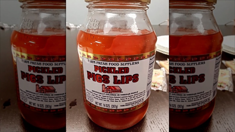 Jar of pickled pig lips on wooden table
