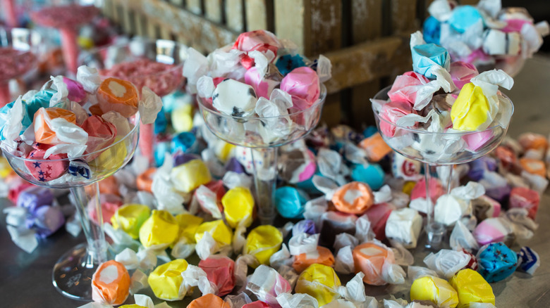 Saltwater taffy in cups and scattered on table