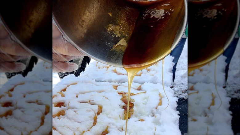 Pouring maple syrup out of pot onto snow