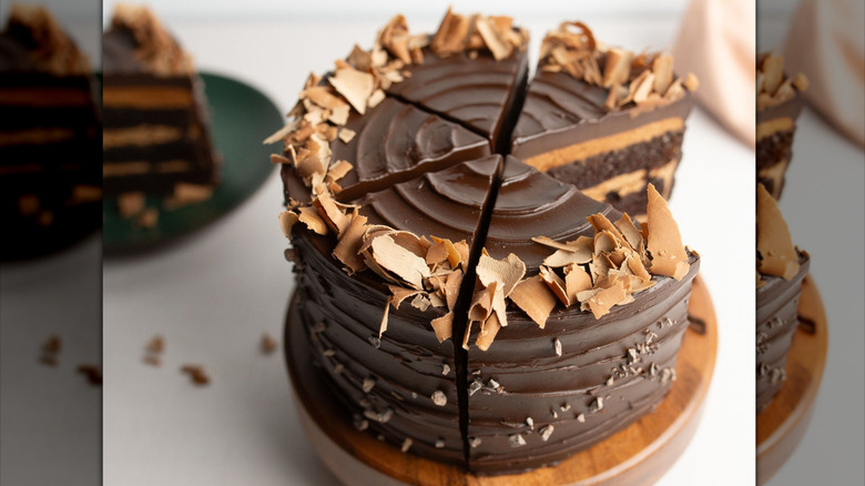 Flour Bakery midnight chocolate cake on a wooden cake stand sliced into five pieces