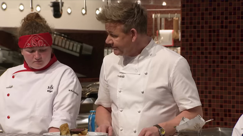 Gordon Ramsay in next to a Hell's Kitchen contestant on the set of Hell's Kitchen
