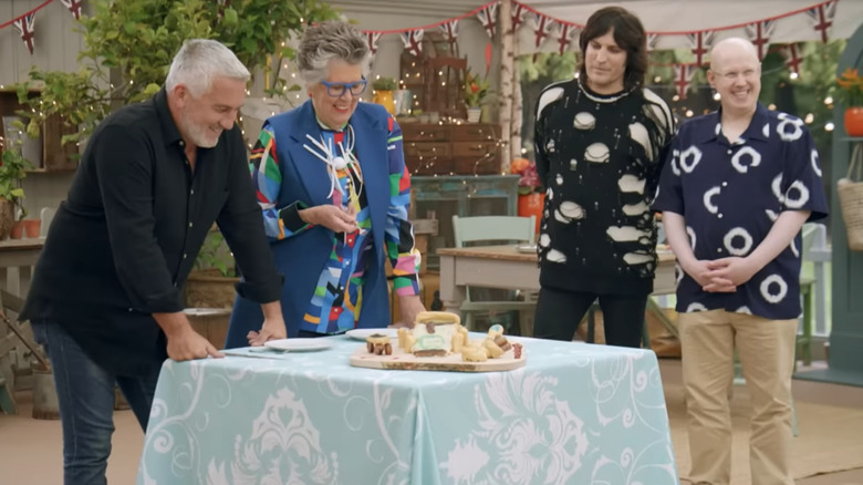 Paul Hollywood, Prue Leith, Noel Fielding and Matt Lucas judging a baked good on set of The Great British Baking Show