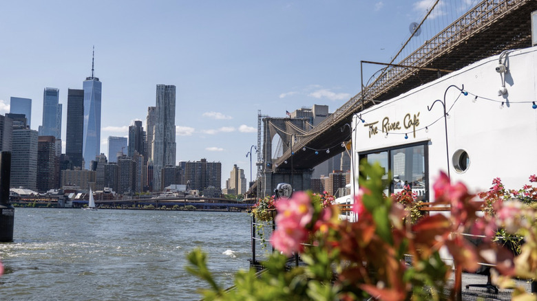 The exterior of The River Café with the Manhattan Skyline and East River in the background