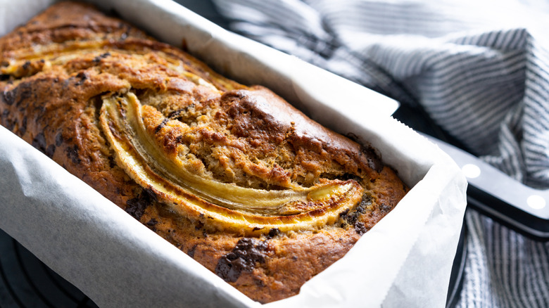 A loaf of banana bread with sliced banana baked into the top