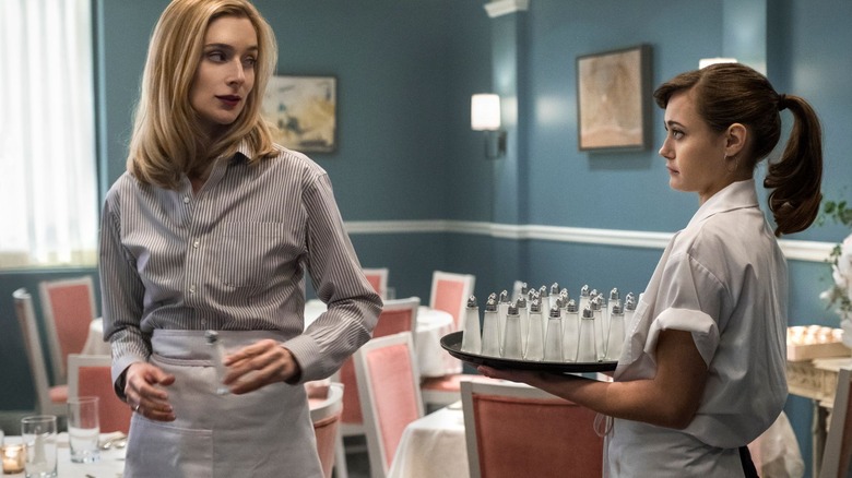 A still from "Sweetbitter," with Simone and Tess giving each other cold stares in the dining room of the restaurant