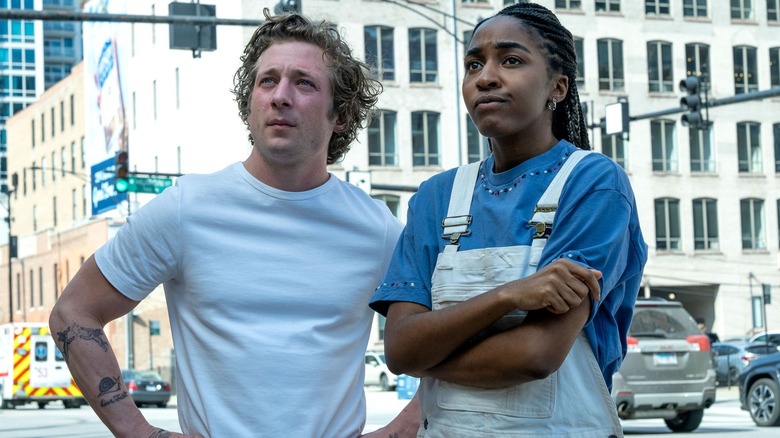 Carmy and Sydney standing on the street looking up in a still from "The Bear"