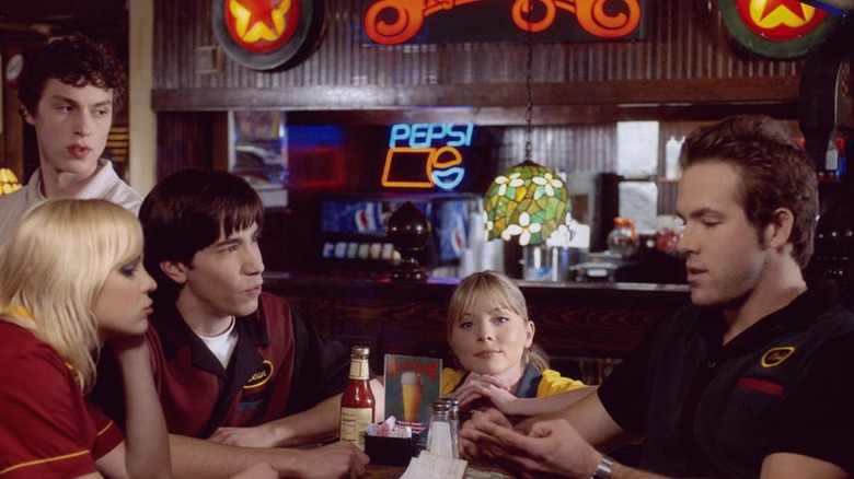The Shenaniganz crew sitting at a booth in the flashy restaurant in a still from "Waiting"