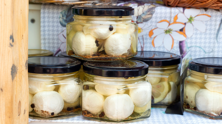 Jars of mozzarella on table