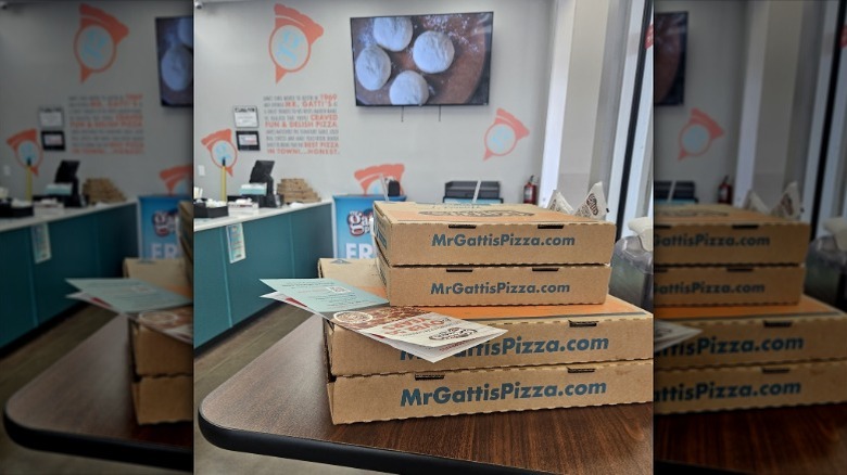 Mr Gatti's Pizza boxes and menu on table