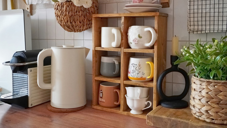 Charming whimsical mug display on a vintage wooden shelf