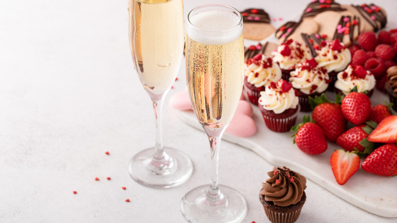 Sparkling wine with a side of strawberries and dessert