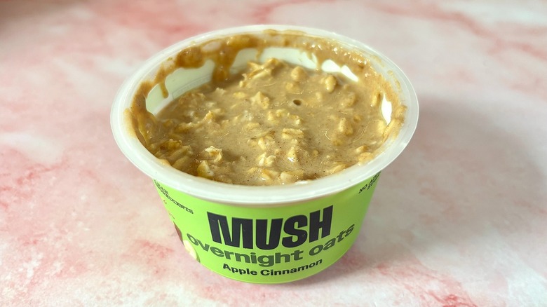 MUSH apple cinnamon overnight oats on pink marble surface