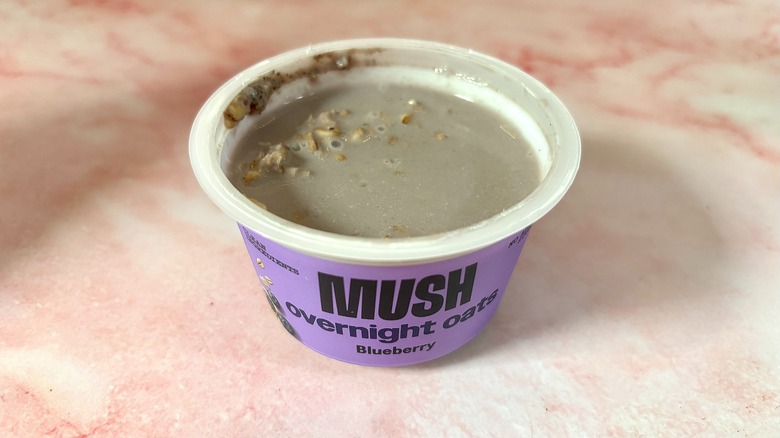 MUSH blueberry overnight oats on pink marble surface