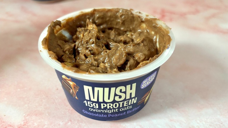 MUSH chocolate peanut butter overnight oats on pink marble surface