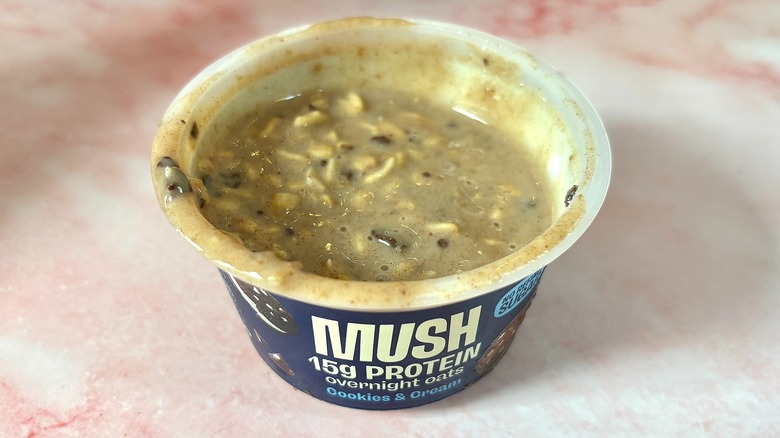 MUSH cookies & cream overnight oats on pink marble surface