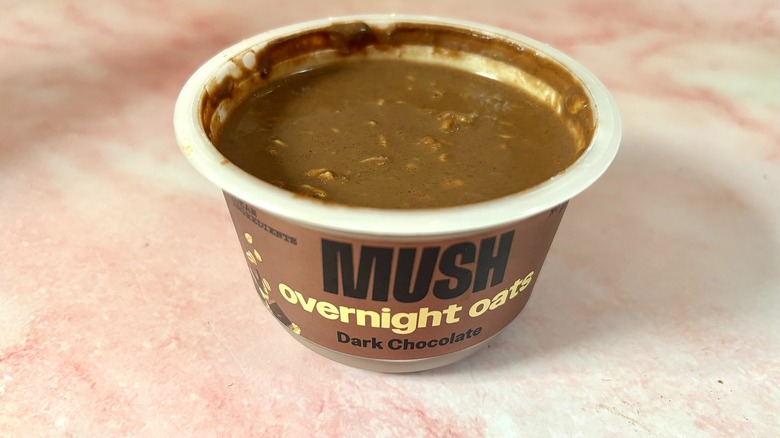 MUSH dark chocolate overnight oats on pink marble surface