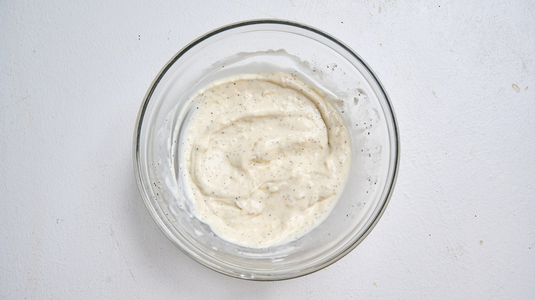 stirring garlic and mayo together in a bowl