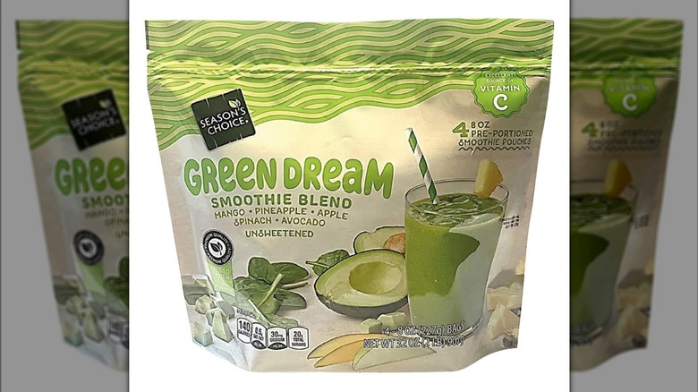 Green smoothie bag displaying thick smoothie in a glass and green ingredients