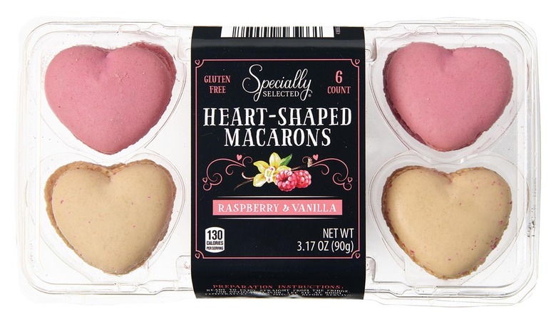 Plastic package box with four visible heart-shaped macarons