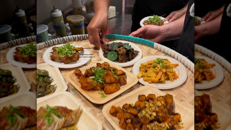Hands cutting pancakes with knife and fork