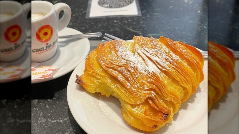 Sfogliatella on plate with cup of coffee