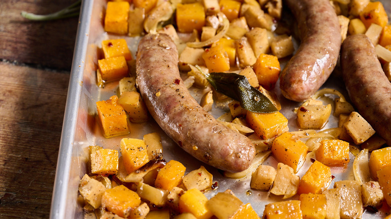 mustardy sausage and apples on sheet tray