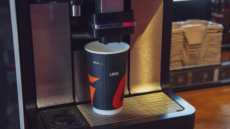 Cup of coffee being brewed into paper cup