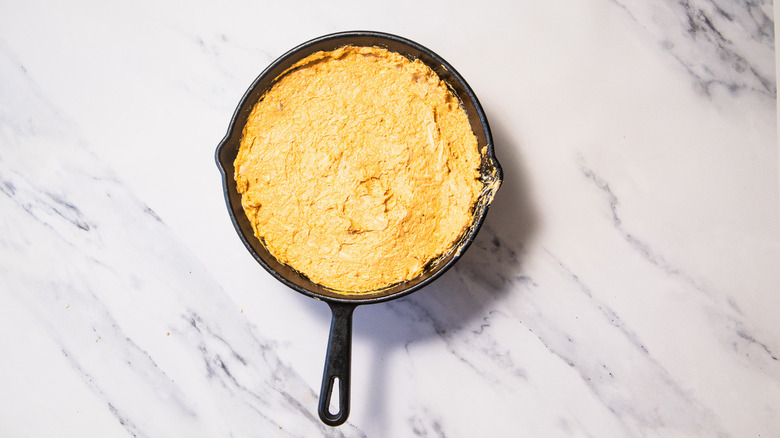 Unbaked Nashville hot chicken dip in cast iron