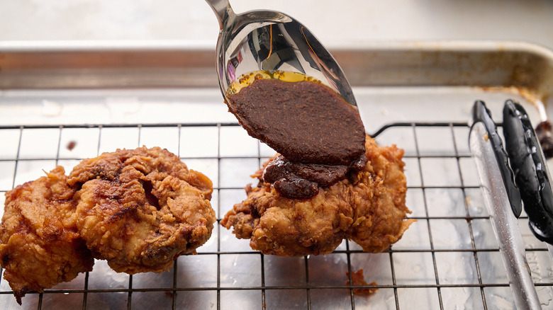 Nashville hot sauce being poured onto chicken