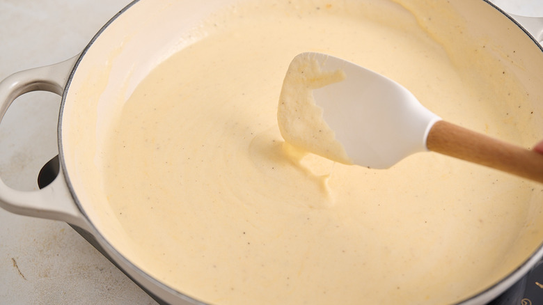 stirring cheese into milk mixture