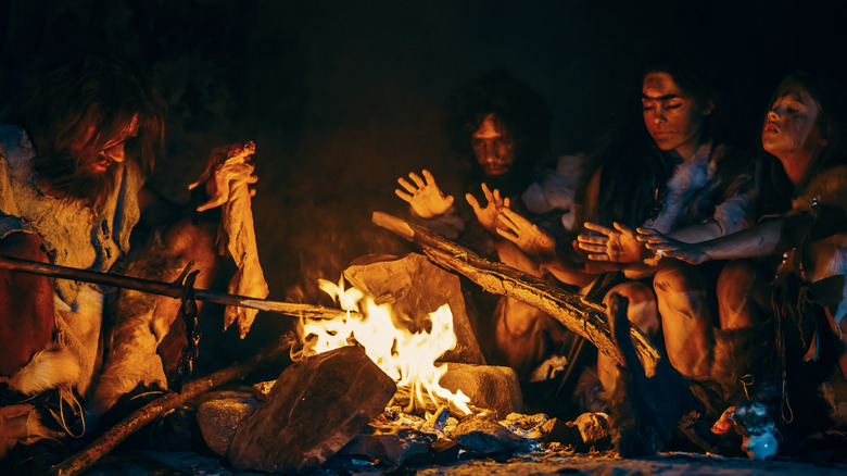 hunter-gatherers cooking over fire