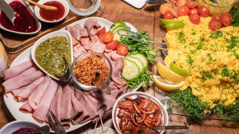 Overhead view of Norwegian cold board meal with scrambled eggs and sliced meats