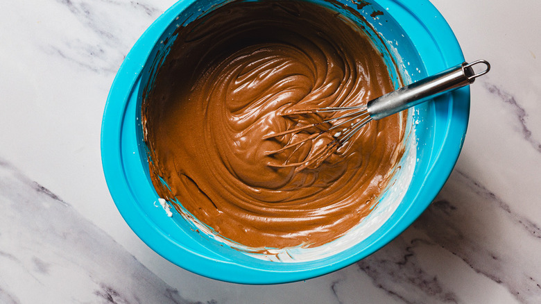 Whisking melted chocolate and whipped cream