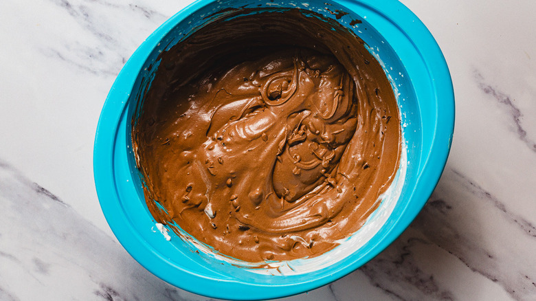 Large bowl with melted chocolate and whipped cream mixture with chocolate chunks