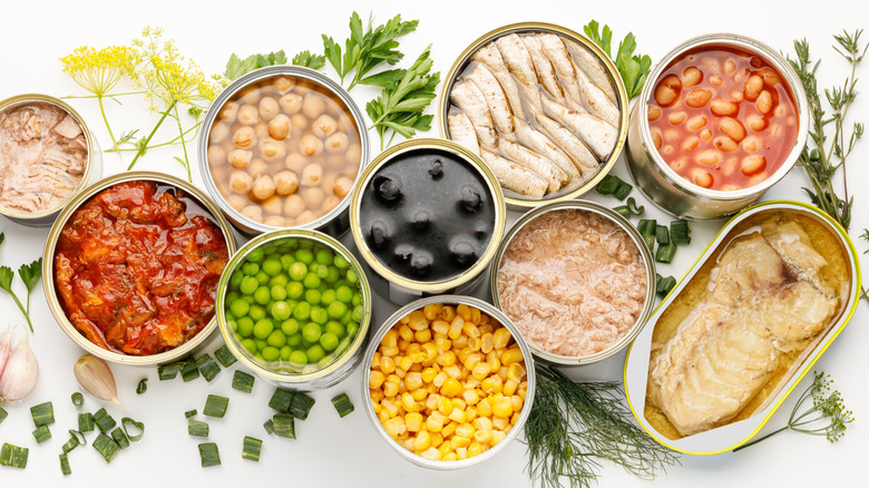 Opened cans of peas, beans, fish, tomatoes, corn, and other foods