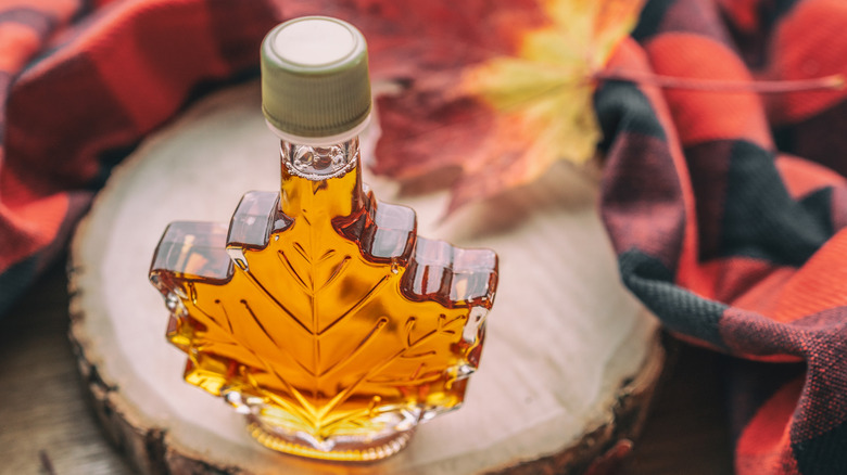 Maple leaf-shaped novelty glass bottle of maple syrup